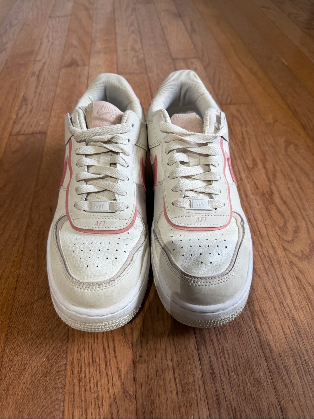 Nike Women’s Low-Top Sneakers in White with Pink Trim
